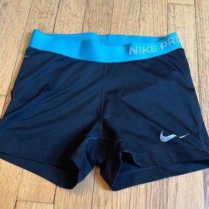 Black Nike Pro shorts with blue waistband